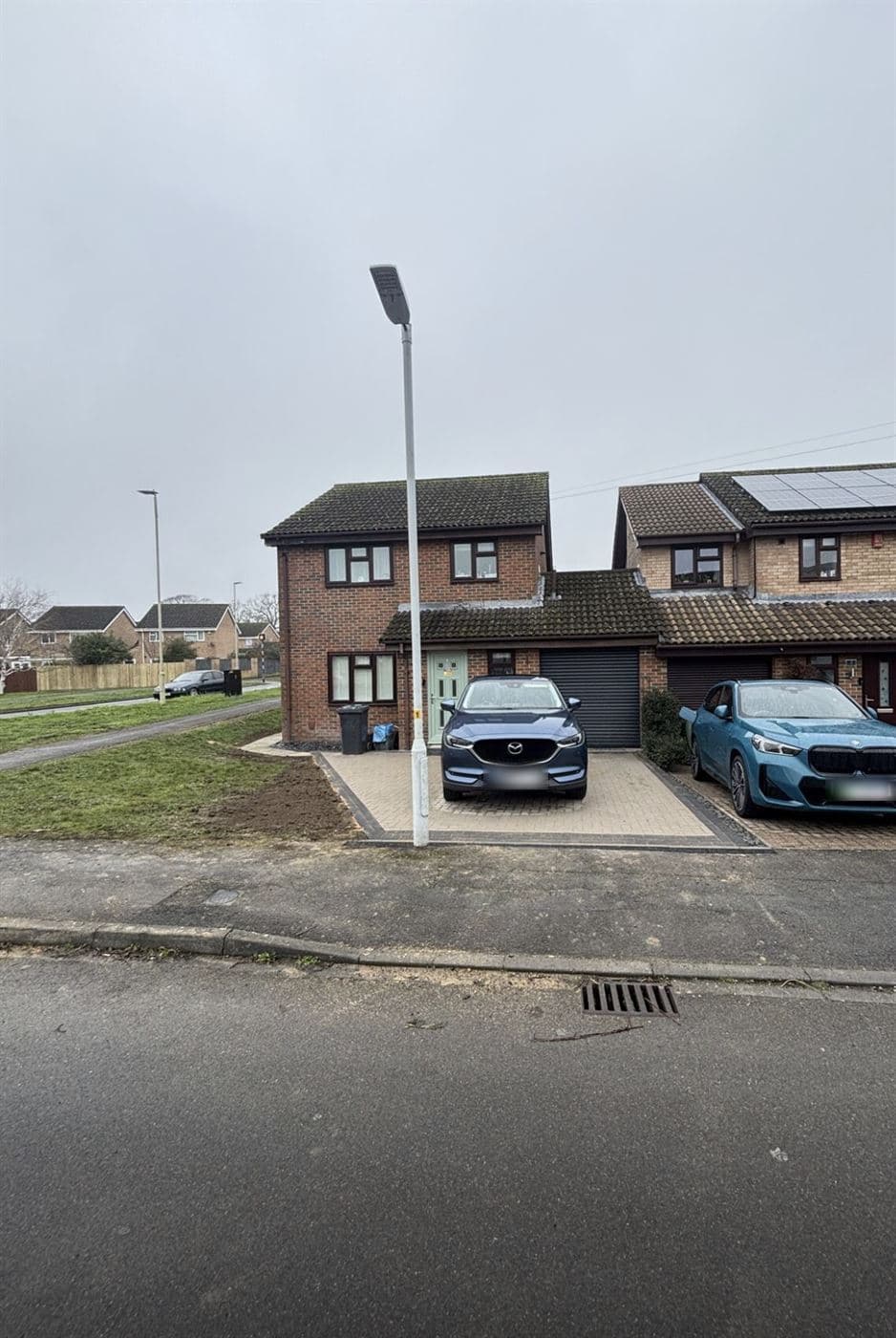 The same property with a completed block paving driveway and parking for two cars, Norwich