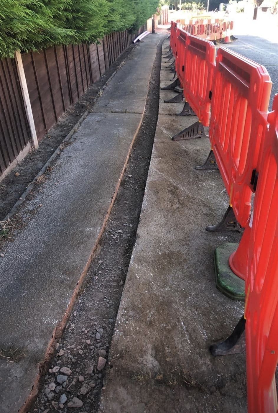Fibre optic duct route running along a footpath ready for backfill