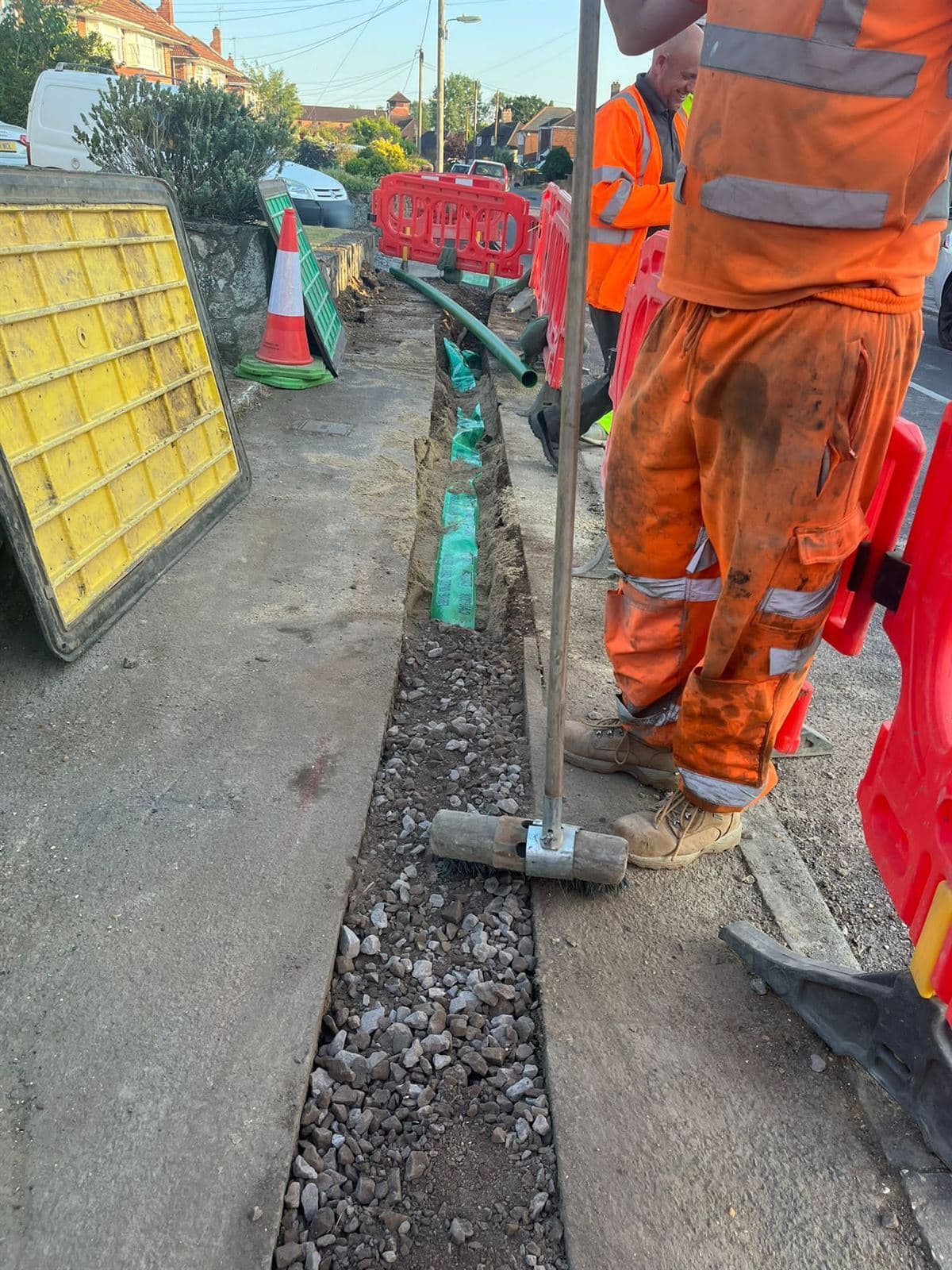 KiKK Groundworks team installing utility ducting behind pedestrian barriers