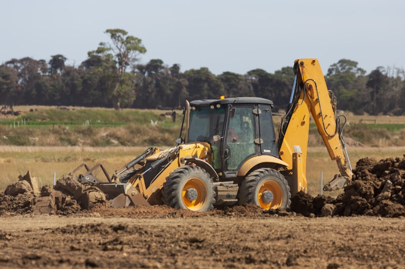 Mini excavator digging drainage trench